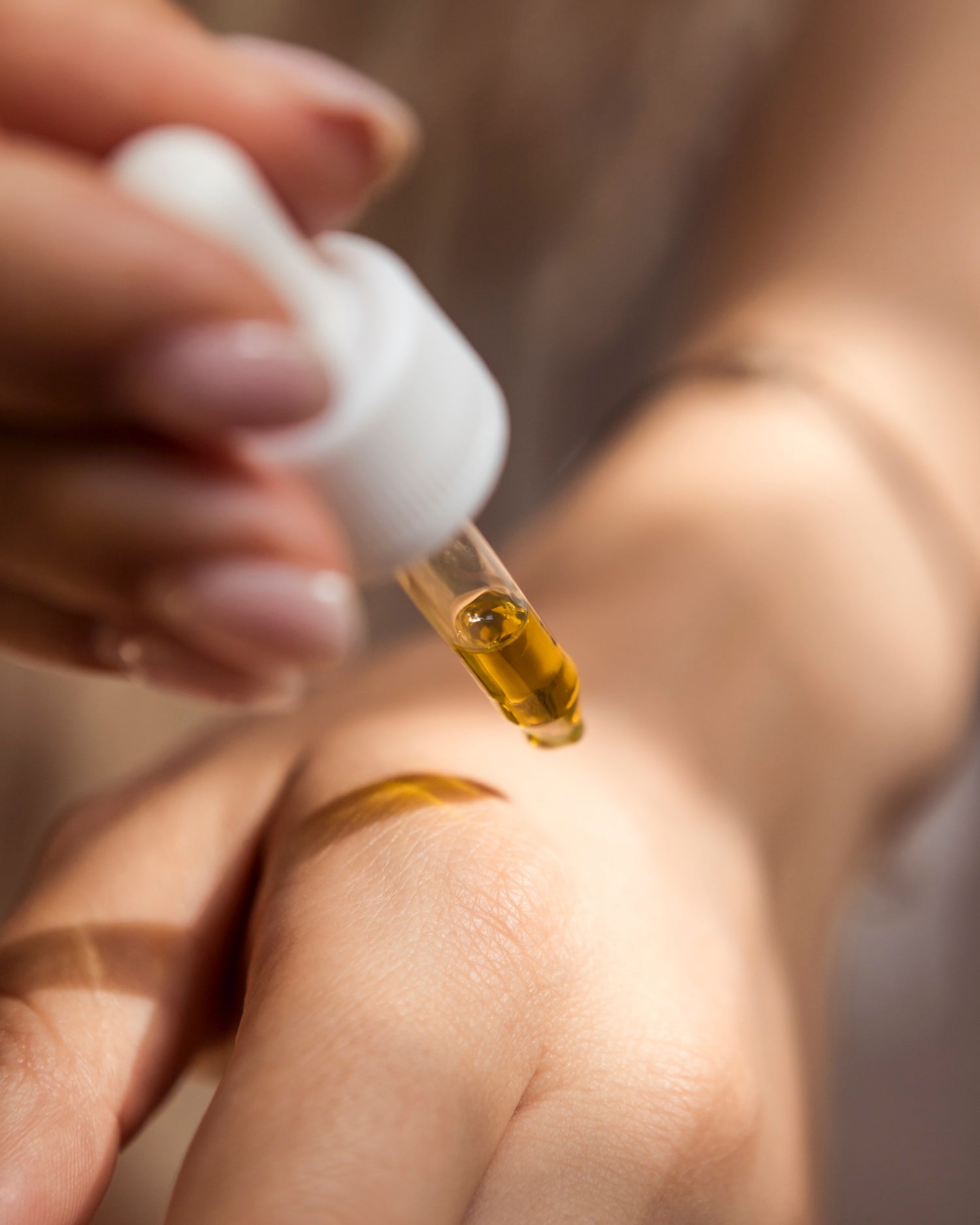 face serum drops on hand skin